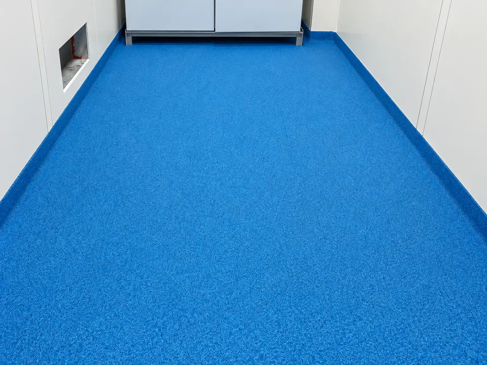 Blue seamless floor in small clean processing room